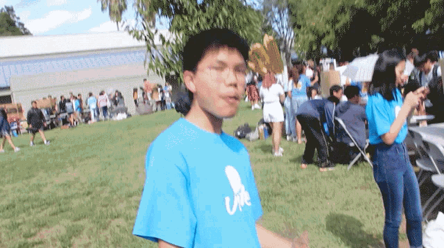 a boy in a blue shirt that says life