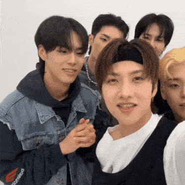 a group of young men are posing for a picture and one has a headband that says polaroid