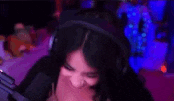 a woman wearing headphones is smiling while playing a video game .