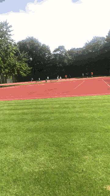 a group of people are running on a track