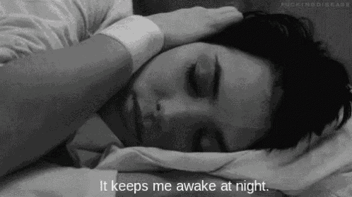 a black and white photo of a woman sleeping with the words `` it keeps me awake at night '' .
