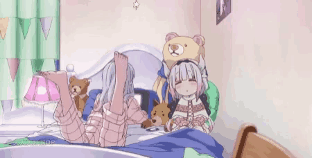 a girl is laying on a bed with a teddy bear and a lamp .