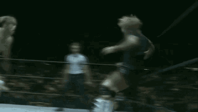 a blurred image of a wrestler jumping in the air