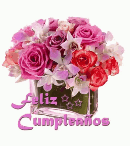 a bouquet of pink roses and orchids in a vase with the words feliz cumpleanos
