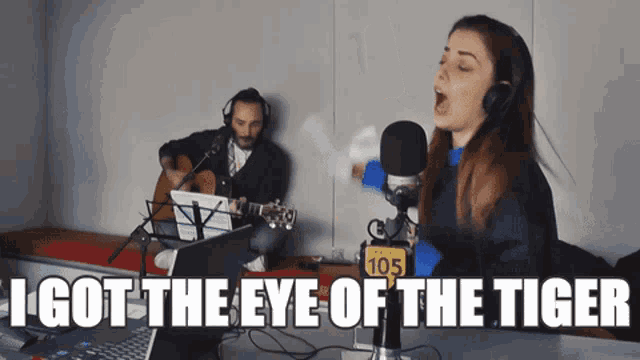 a woman singing into a microphone next to a man playing a guitar with the words i got the eye of the tiger