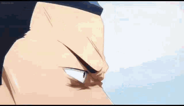 a close up of a man 's face with a ponytail and a smile .