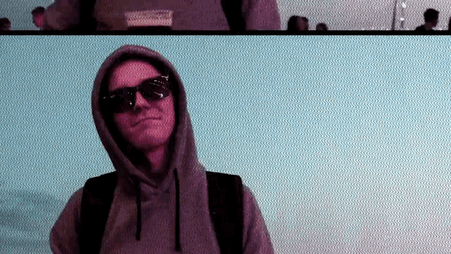 a man wearing sunglasses and a hoodie with the word supreme on the front