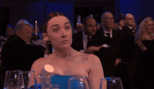 a woman in a blue dress holds a bottle of water