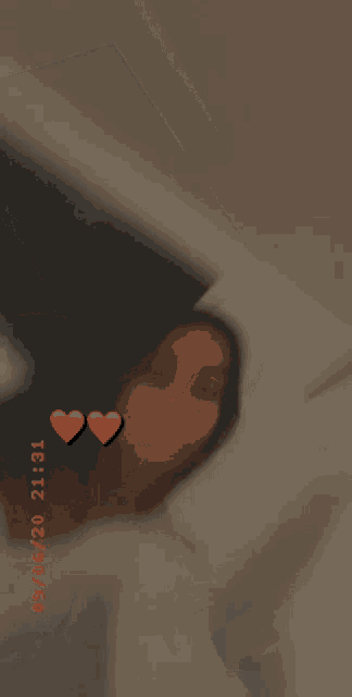 a girl is sticking her tongue out with two red hearts on her face .
