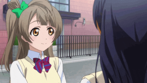 a girl with a green bow in her hair is smiling