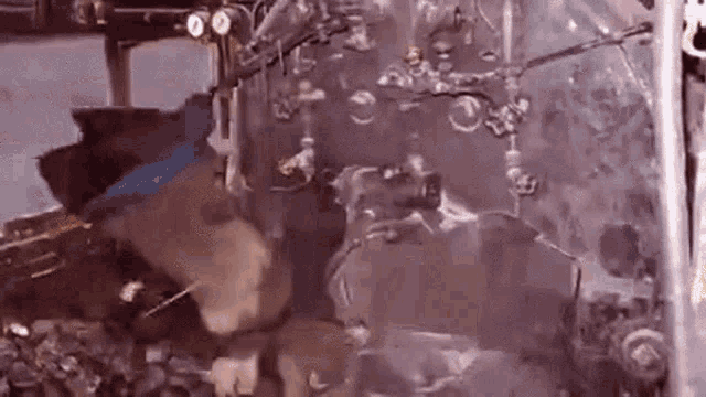 a close up of a machine with smoke coming out of it and a person standing in front of it .