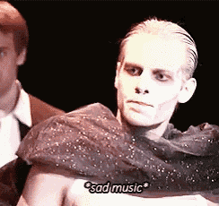 a man with a scarf around his shoulders says sad music .