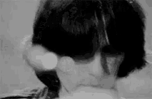 a black and white photo of a man with sunglasses on his face .