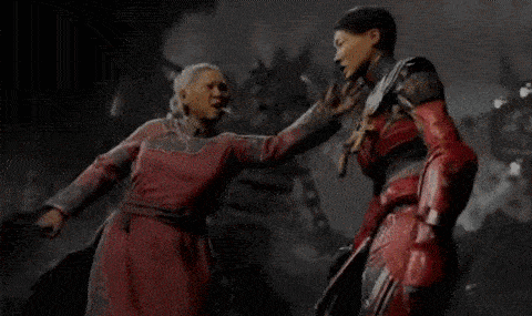a woman in a red dress is standing next to another woman in a red costume