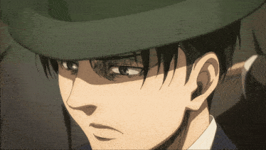 a close up of a man 's face wearing a hat with the letter e on it