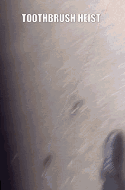 a close up of a person 's face with the words toothbrush heist above it