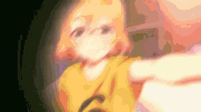 a blurry picture of a girl with a yellow shirt