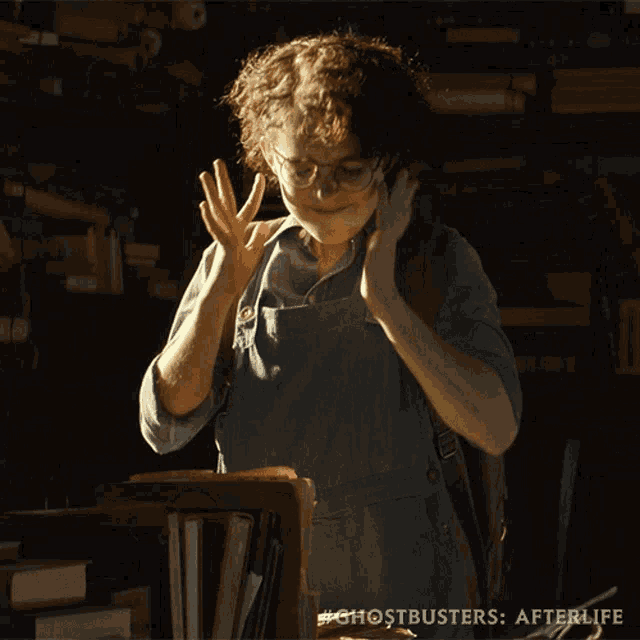 a ghostbusters afterlife poster shows a girl talking on a phone