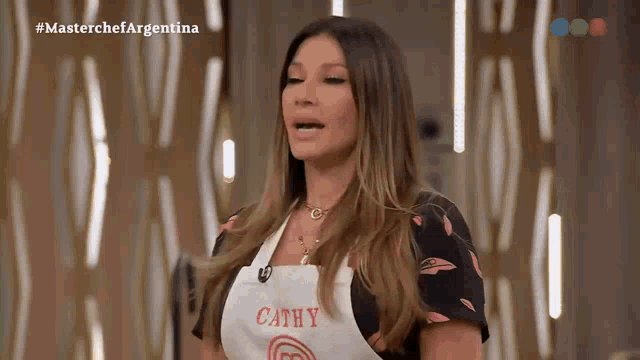 a woman wearing a white apron with cathy written on it