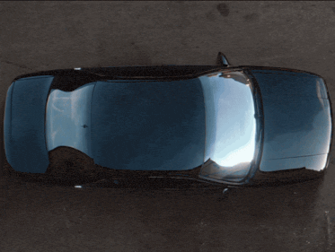 a sign that says shift gears with a car in the background