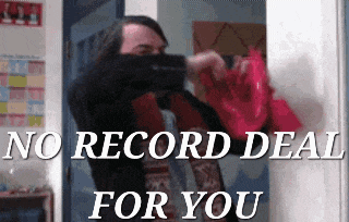 a man holding a red bag with the words " no record deal for you " on the bottom