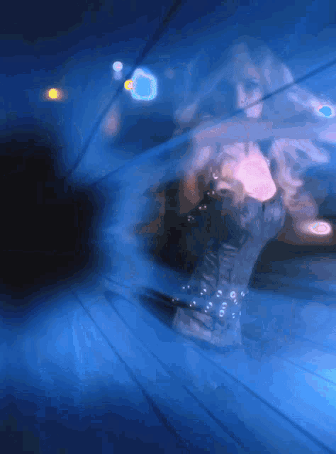 a woman in a black corset is dancing in a dark room