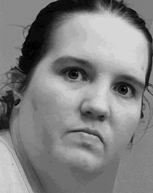 a black and white photo of a woman 's face