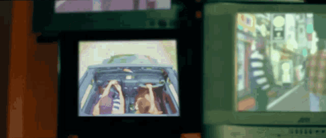 two tv screens one of which says jvc on the bottom left