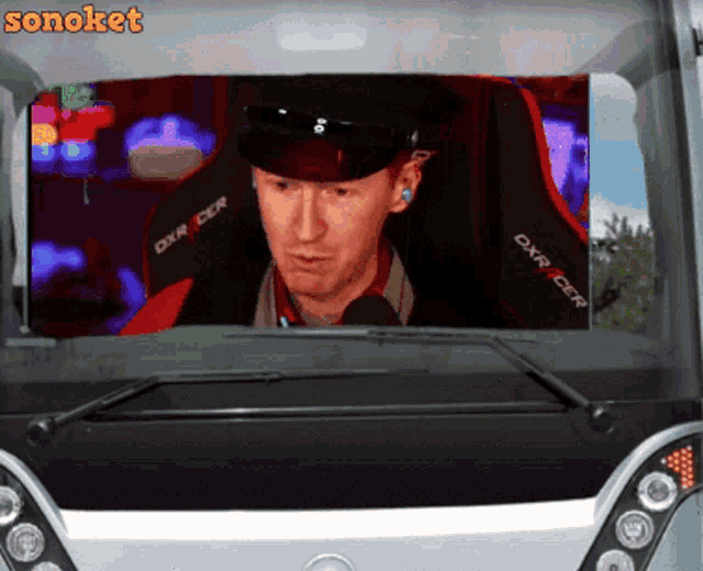 a man in a hat is sitting in a dxr rider chair