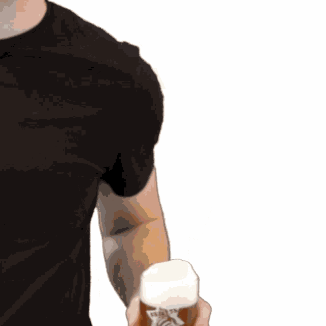 a man in a black shirt is holding up a glass of beer that says karls on it