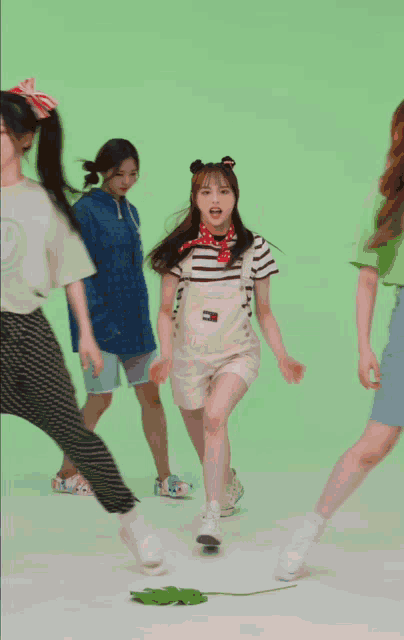 a girl wearing overalls with a tommy hilfiger logo on it