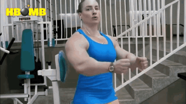 a woman in a blue tank top stands in front of a machine that says power