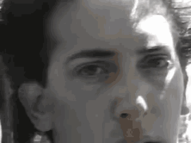a close up of a person 's face in a black and white photo