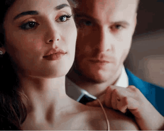 a close up of a man and a woman looking at each other .