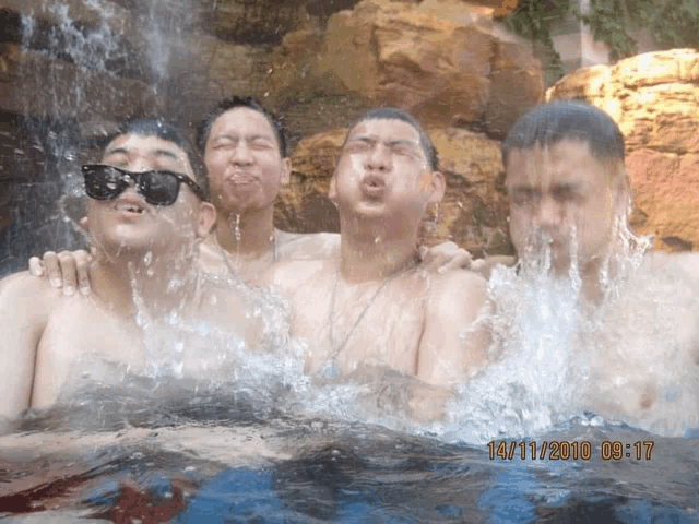 a picture of four men in a waterfall was taken on 14/11/2010 at 09:17