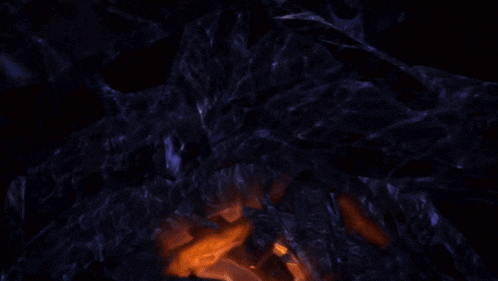 a close up of a glowing object in a dark room