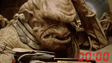 a close up of a monster with a clock that says 00:00 in red