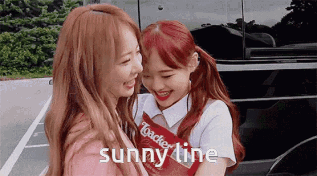 two girls are hugging each other and the words sunny line are on the bottom of the image