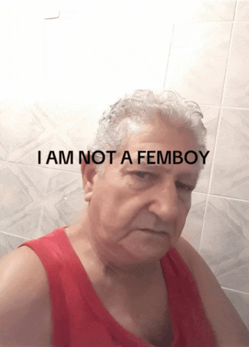 a man in a red tank top with the words " i am not a femboy " on the bottom