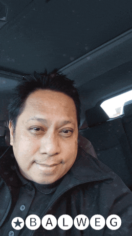 a man in a car with the word balweg on the bottom right