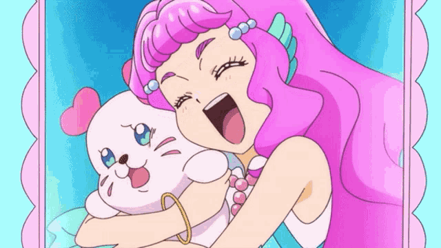 a girl with pink hair is holding a seal in her arms .