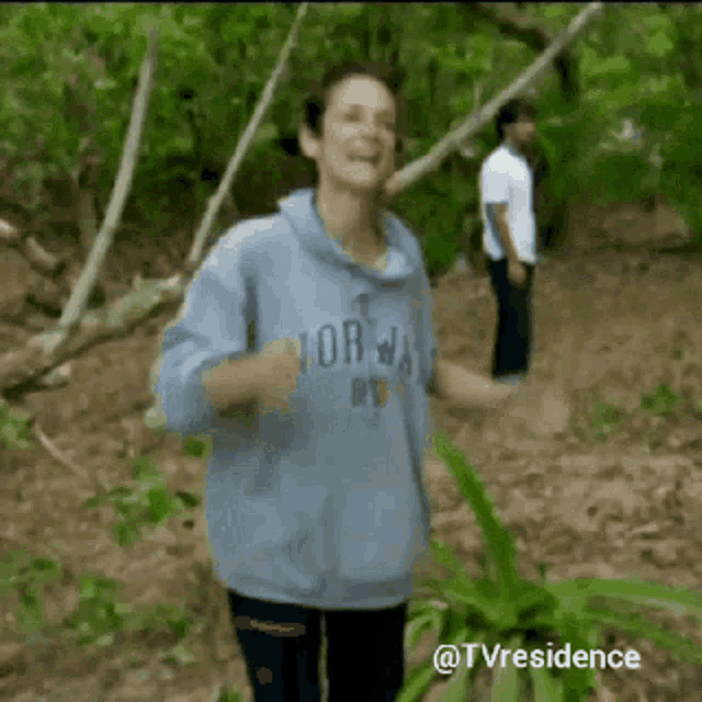 a woman wearing a blue sweatshirt that says norway on it