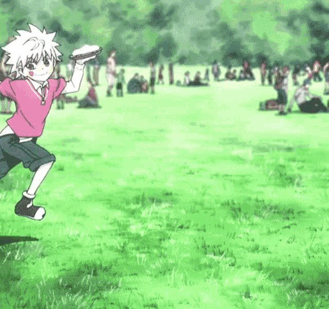 a boy in a pink shirt is jumping in the air holding a frisbee