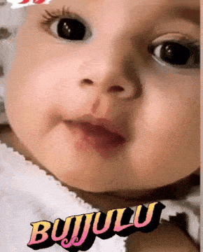 a close up of a baby 's face with the word bujululu in the corner