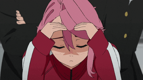 a girl with pink hair is holding her head in her hands