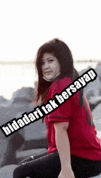 a woman wearing a red shirt with the number 1 on the front