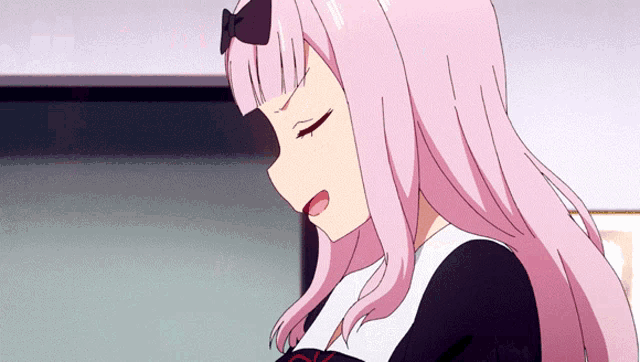 a close up of a girl with pink hair and a bow on her head