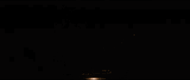 a group of men are standing in a dark room with guns .