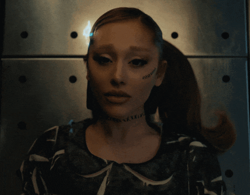 a close up of a woman with a tattoo on her face that says ' ariana grande '