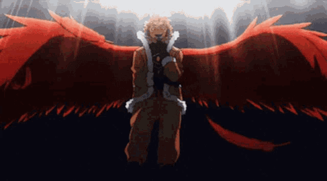 a man with red wings is standing in a dark room .